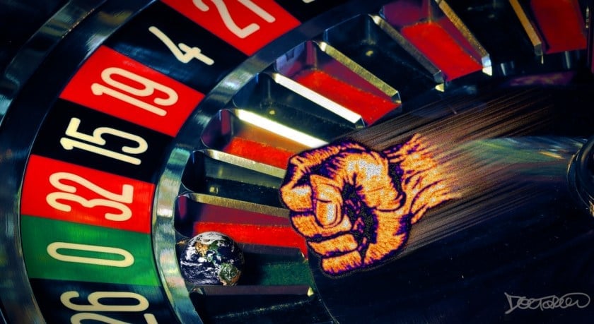 A closeup of a roulette wheel at rest. The ball has been replaced with the planet Earth. A flying fist is jetting through the air at it and is about to knock it.